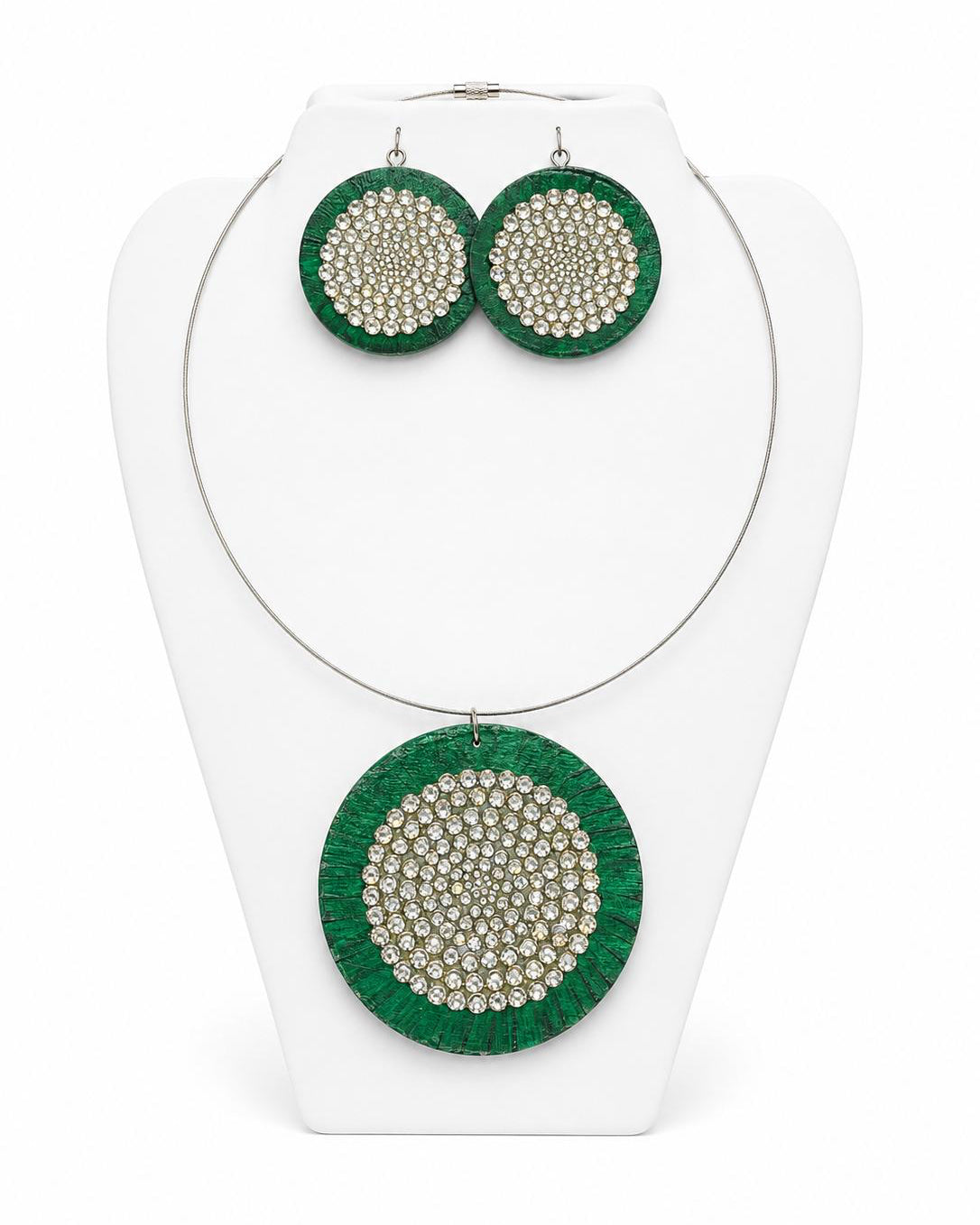 Green circular earrings with bead embellishments on a white stand.