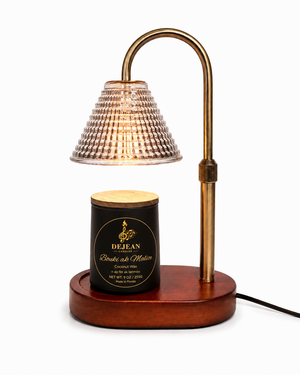 Decorative lamp with a wooden base and brass arm on a white background