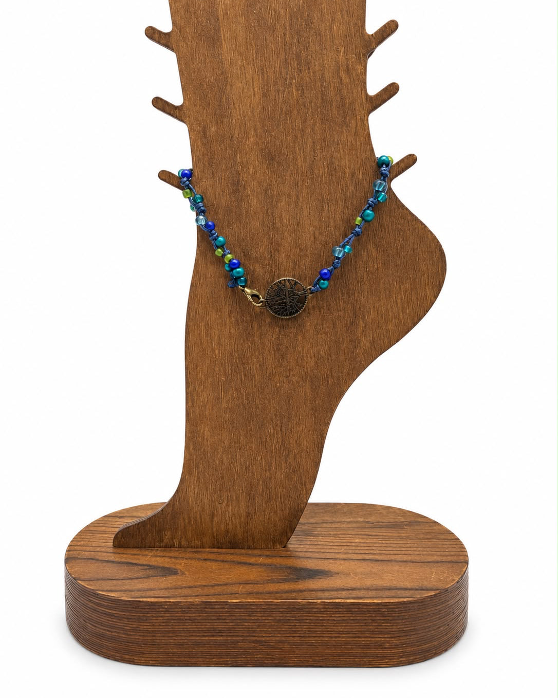 Wooden jewelry stand with a bracelet on a white background