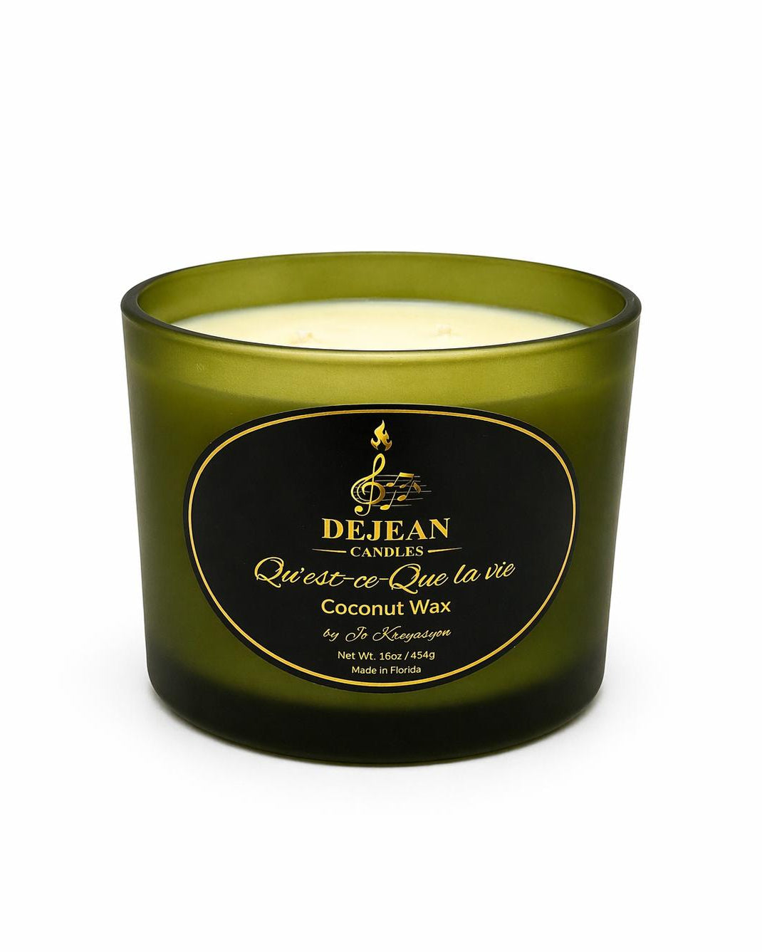 Green candle with a black label on a white background