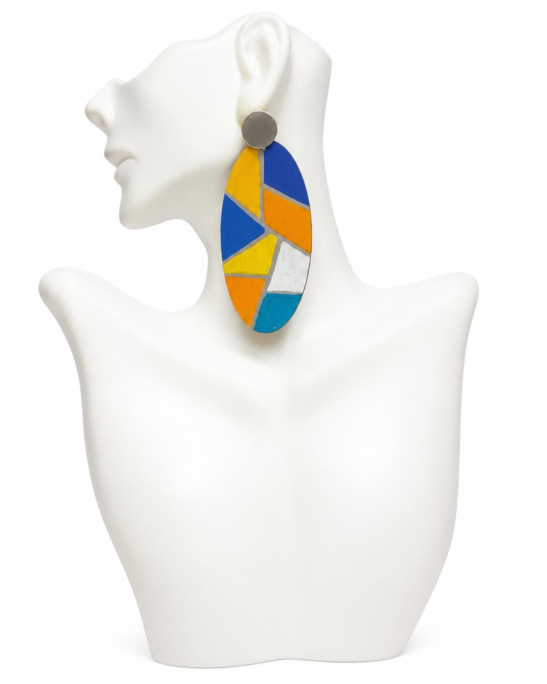 Colorful geometric earrings on a white mannequin bust.
