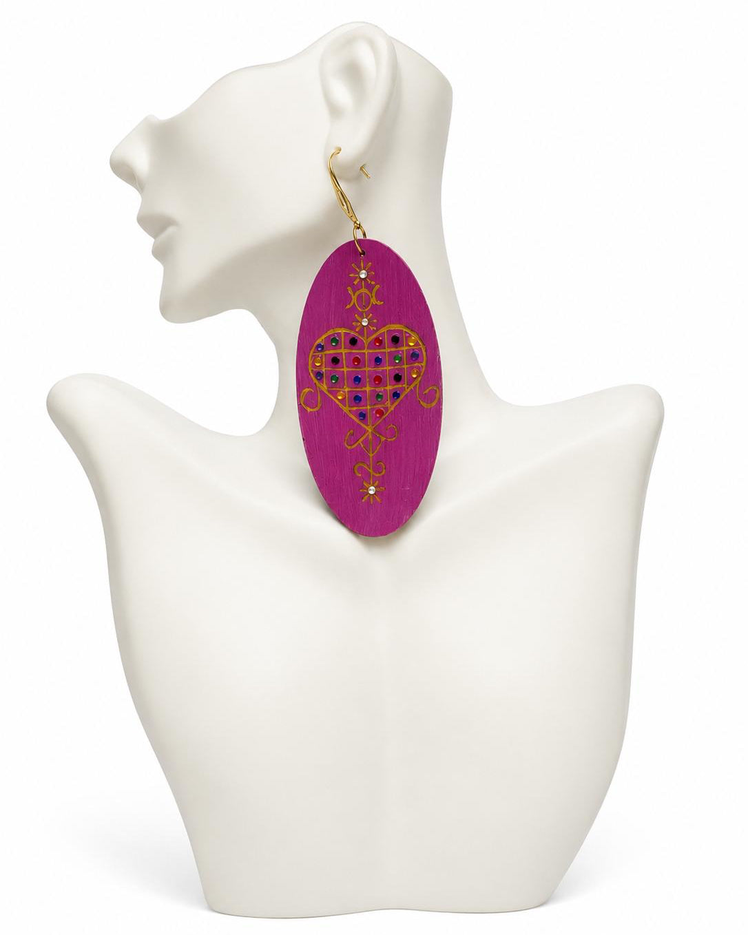 Earring with heart design on a mannequin bust against a white background
