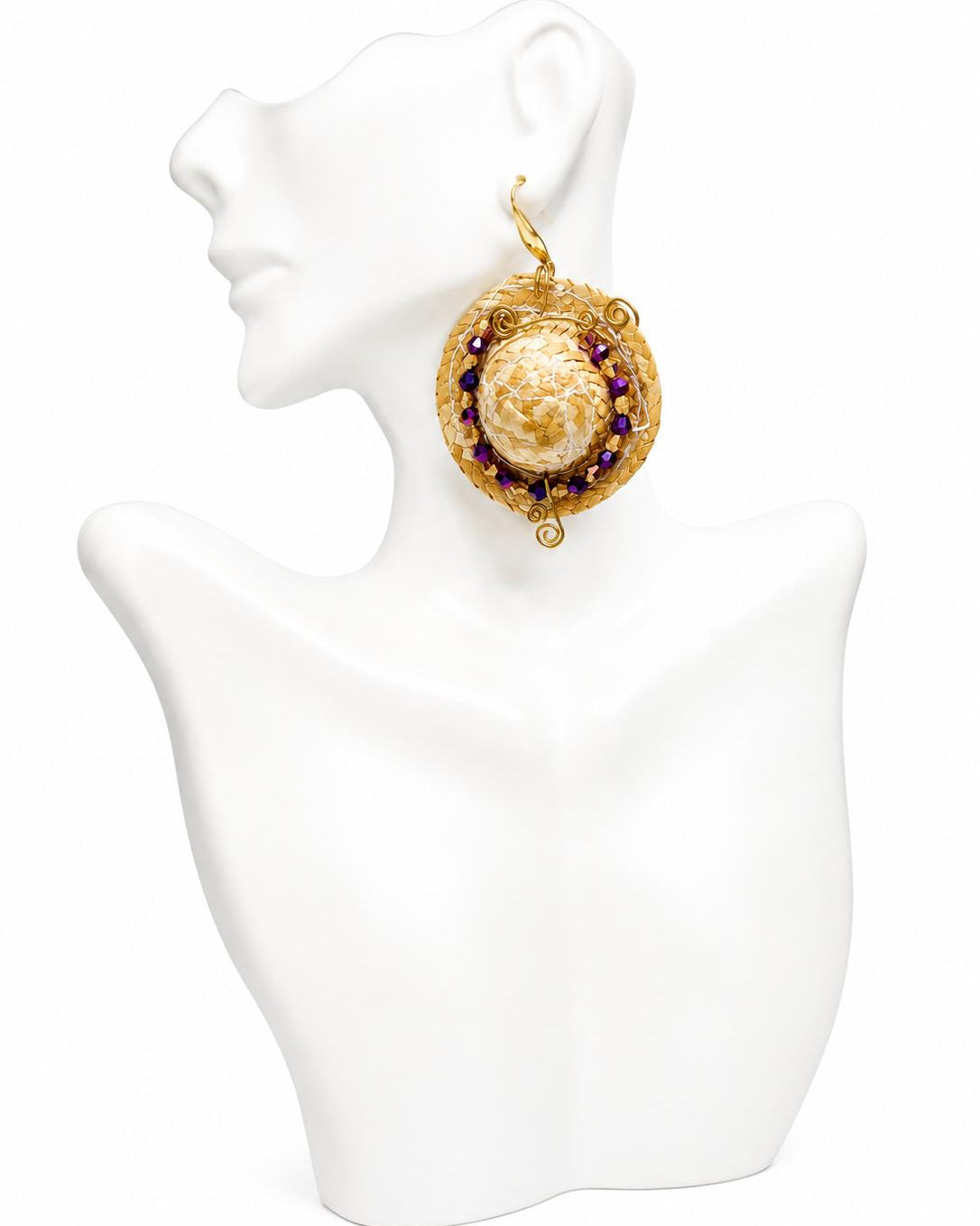Gold and pearl earring on a white mannequin bust