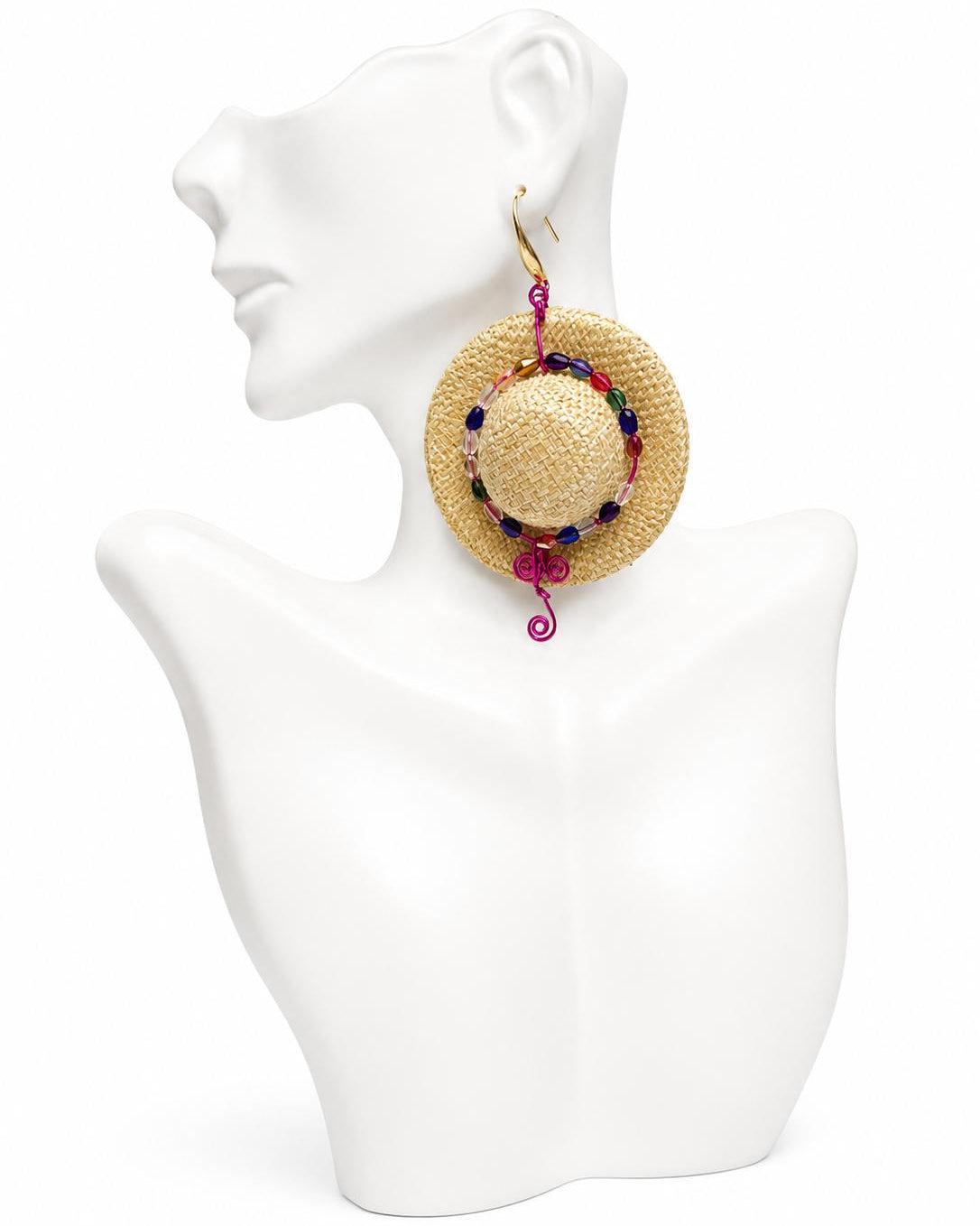 Woven round earrings with colorful beads on a white mannequin bust.