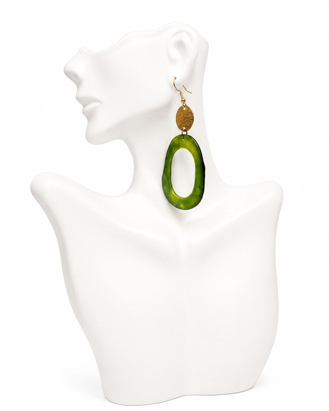 Green earrings on a white mannequin bust