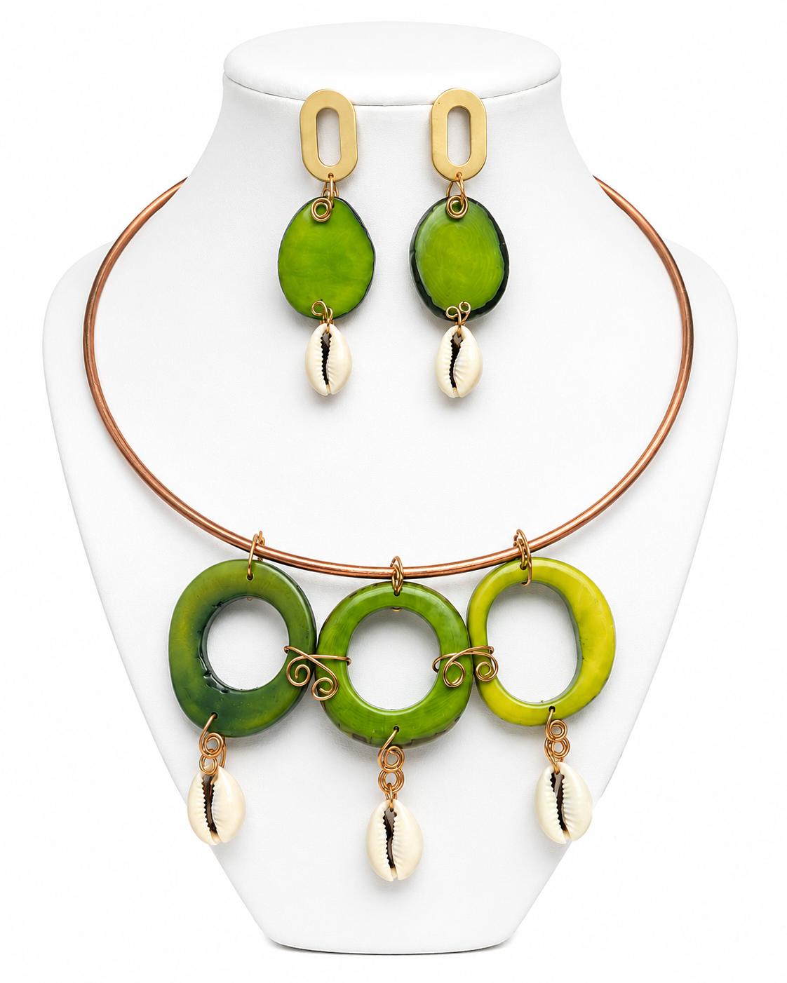 Jewelry set with green circular pendants and gold accents on a white stand.