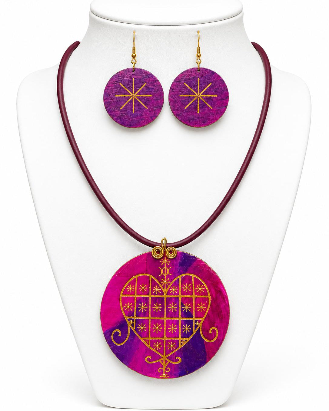 Jewelry set with purple and pink circular pendant and matching earrings on a white stand.
