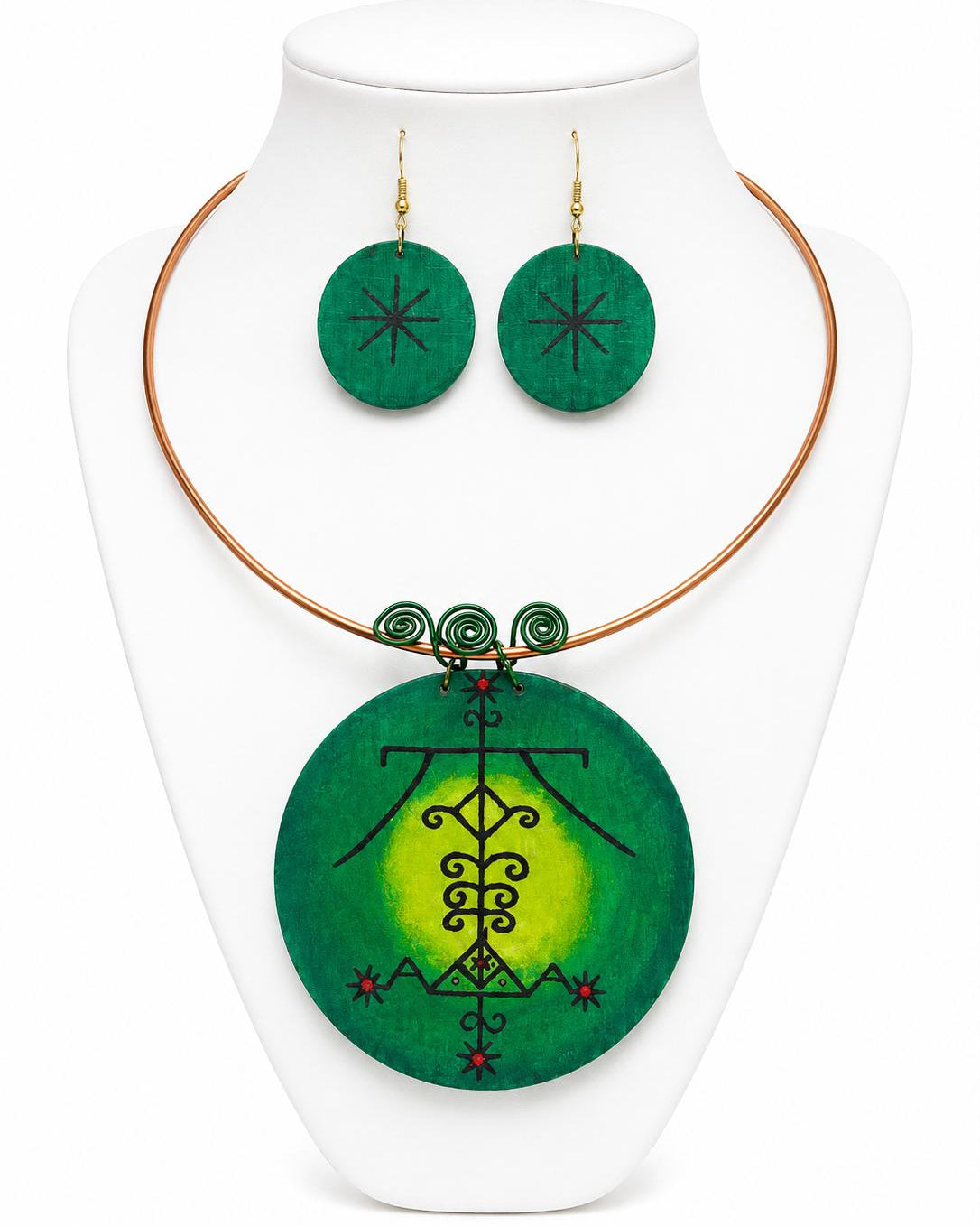 Green pendant necklace and earrings on a white stand