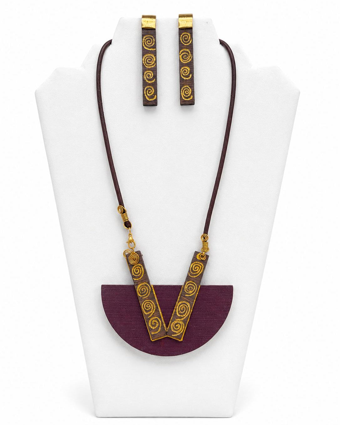 Jewelry set with necklace and earrings on a white stand