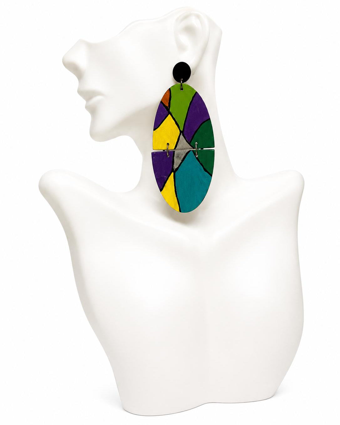 Colorful geometric earrings on a white mannequin bust